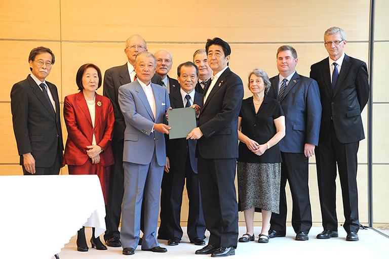 Photo of Chairman Yōhei Sasakawa of Nippon Foundation and participants submitting recommendations to Prime Minister Shinzo Abe