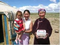 Photo of a family in Mongolia holding a medicine box