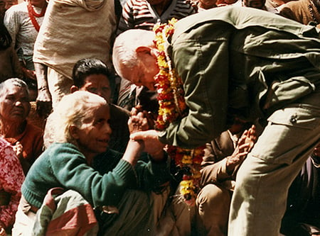 Photo of first chairman Ryoichi Sasakwa offering encouragement to a woman affected by leprosy