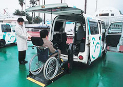 Photo of a wheelchair user boarding a wheelchair-accessible vehicle