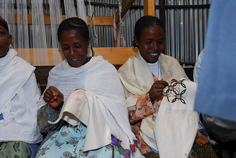 Photo of women affected by leprosy sewing