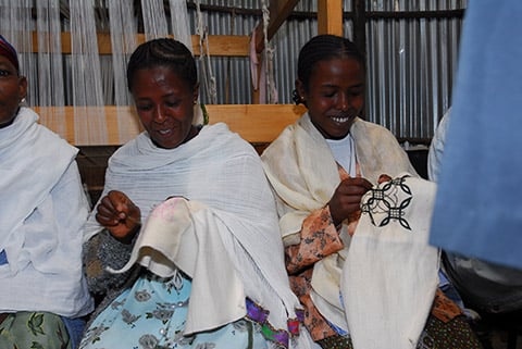 Photo of women affected by leprosy sewing