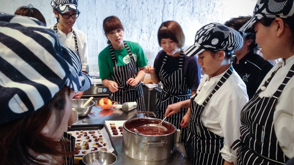 Photo of persons with disabilities learning how to make luxury chocolate