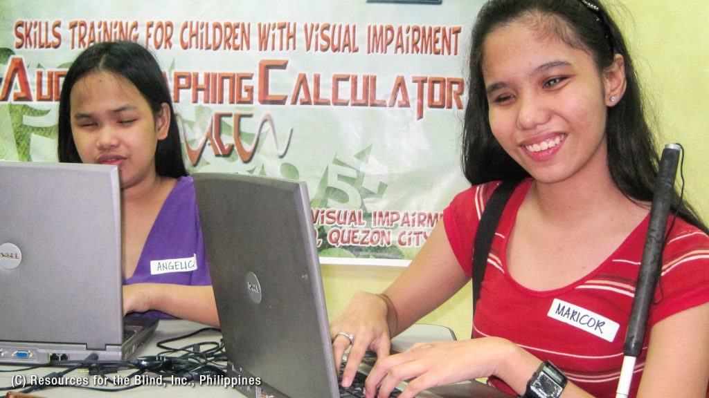 Photo of visually impaired women learning through the use of ICT