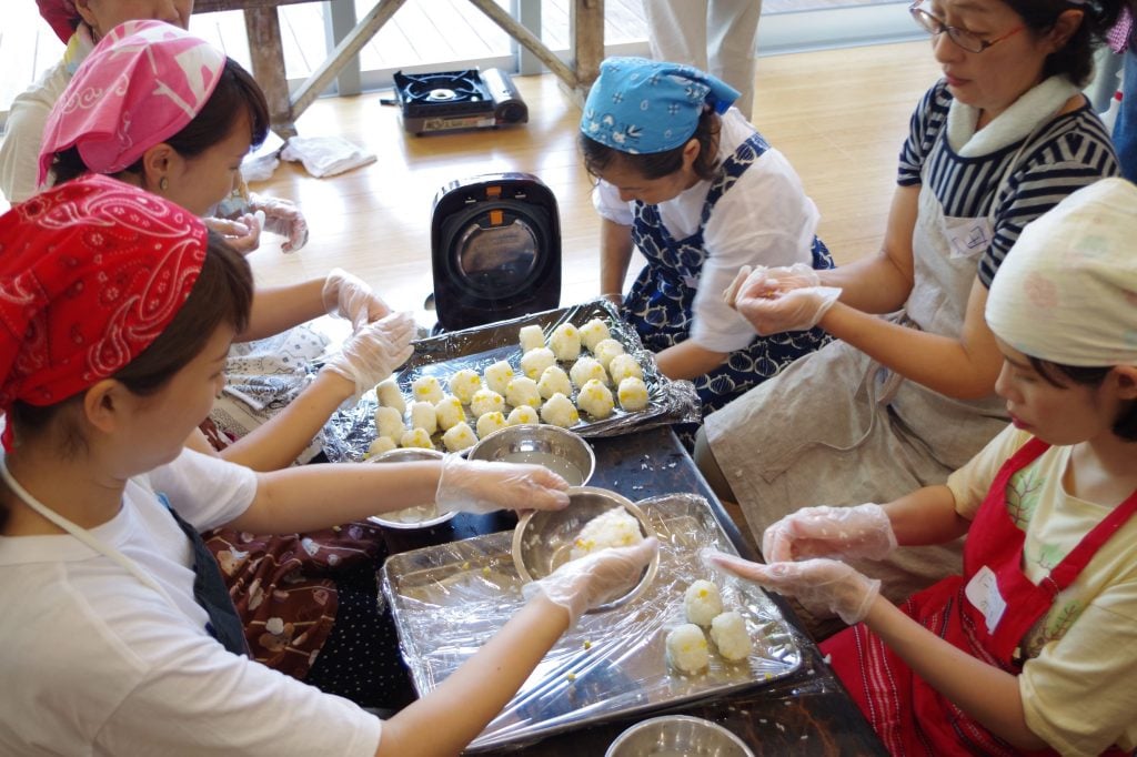 写真：おにぎりを作る参加者とスタッフたち