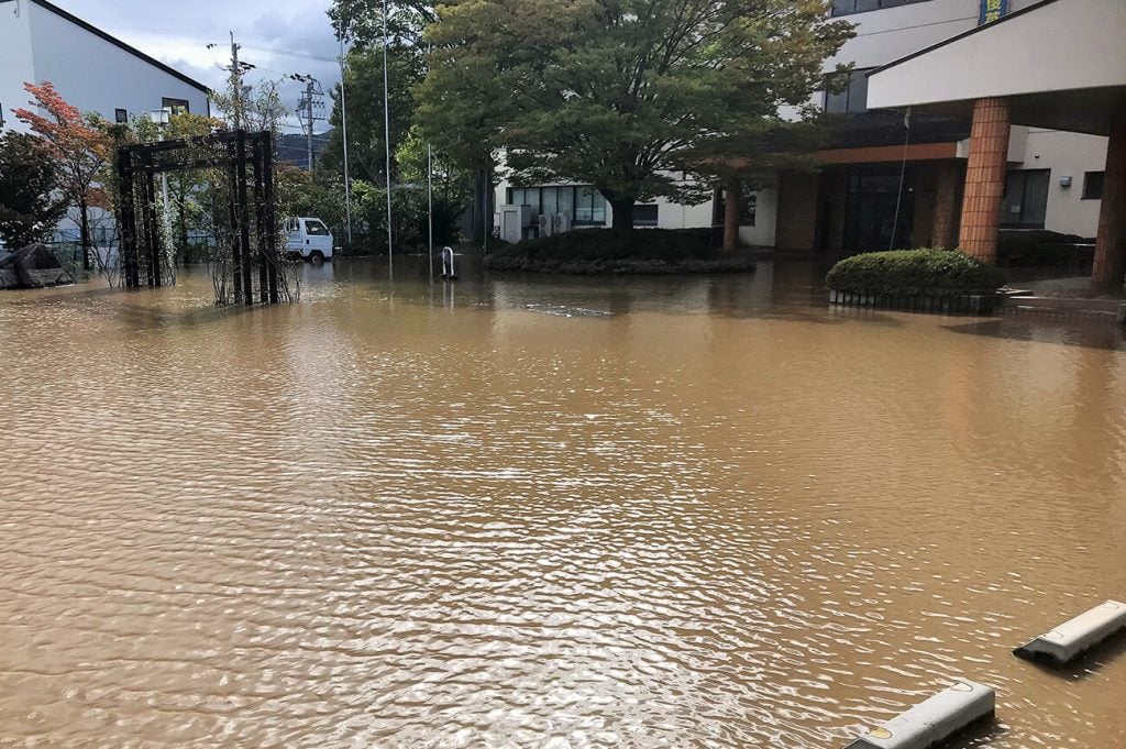 写真:玄関や駐車場が泥水に浸水した様子(10月13日、学校提供)