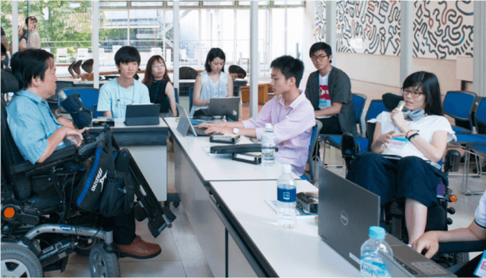 写真:講義室の中で講師と意見を交わす複数のスカラーたち
