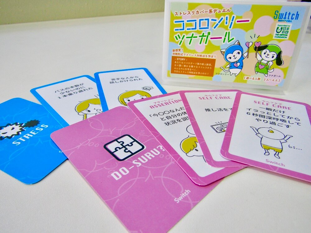 写真：カードゲーム「ココロンリーツナガール」のパッケージとカード