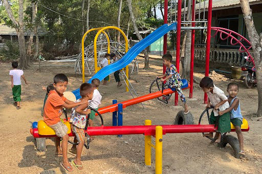 Photo of children playing on playground equipment