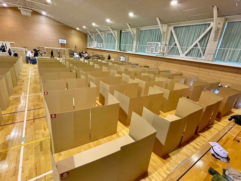Photo of cardboard beds installed in a gymnasium
