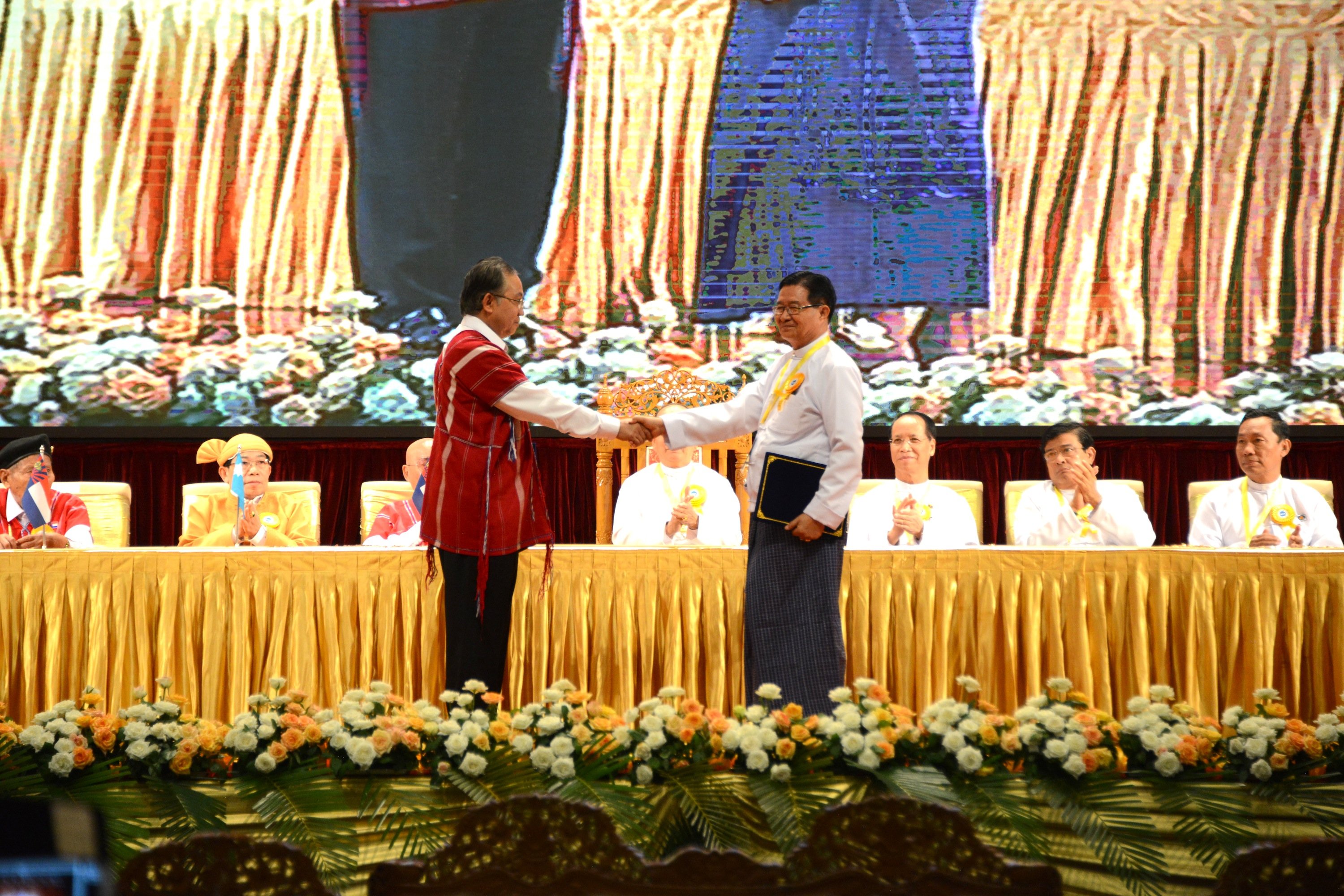 Photo of a scene from a signing ceremony of a ceasefire agreement