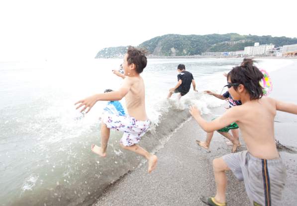 写真:海をめがけて走っていく子どもたち